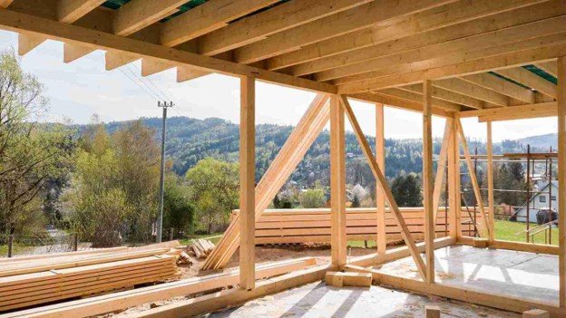 A underconstruction wood deck with view outside.